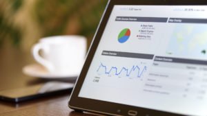 Tablet screen displaying website analytics and data charts.