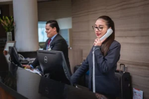 Professional customer support representative answering an inbound phone call at a service desk