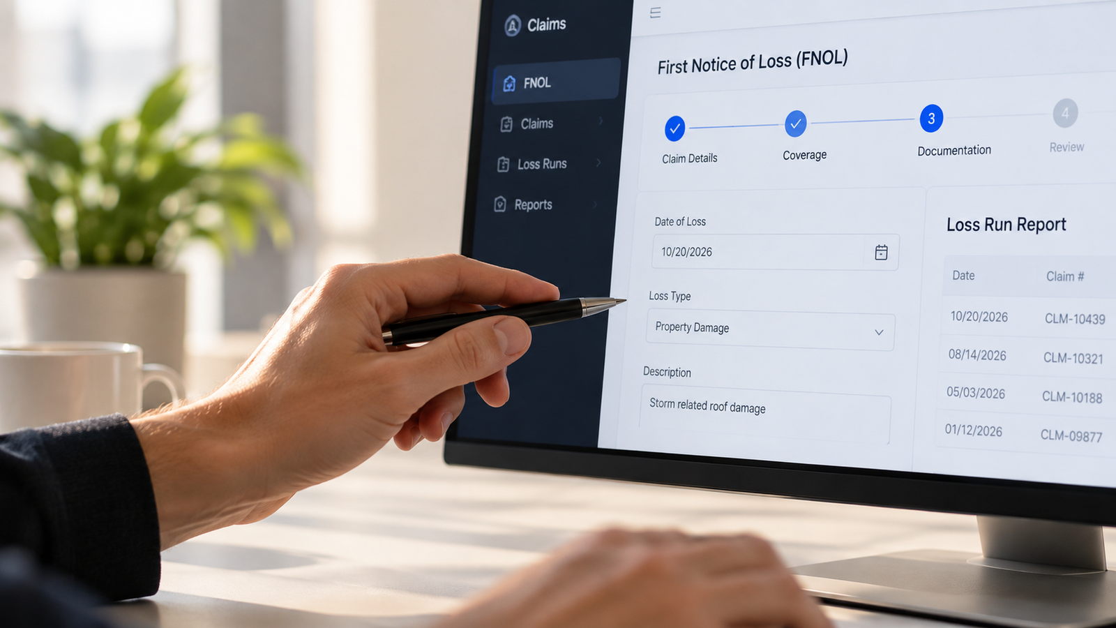 Close-up of a person pointing a pen at a computer screen showing an insurance First Notice of Loss (FNOL) software form.